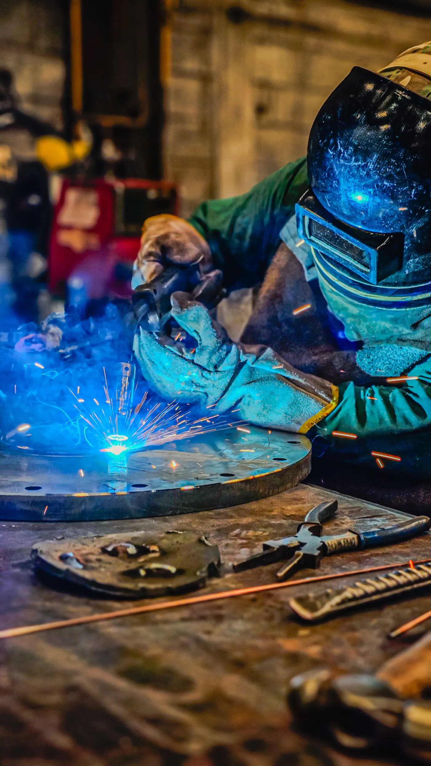 Industrial welder creating sparks during precision welding